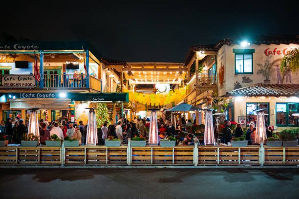 San Diego, CA, USA - Dec 27, 2022: Tourist of Old Town San Diego enjoy dinner and the night life at an outdoor restaurant during a December evening.